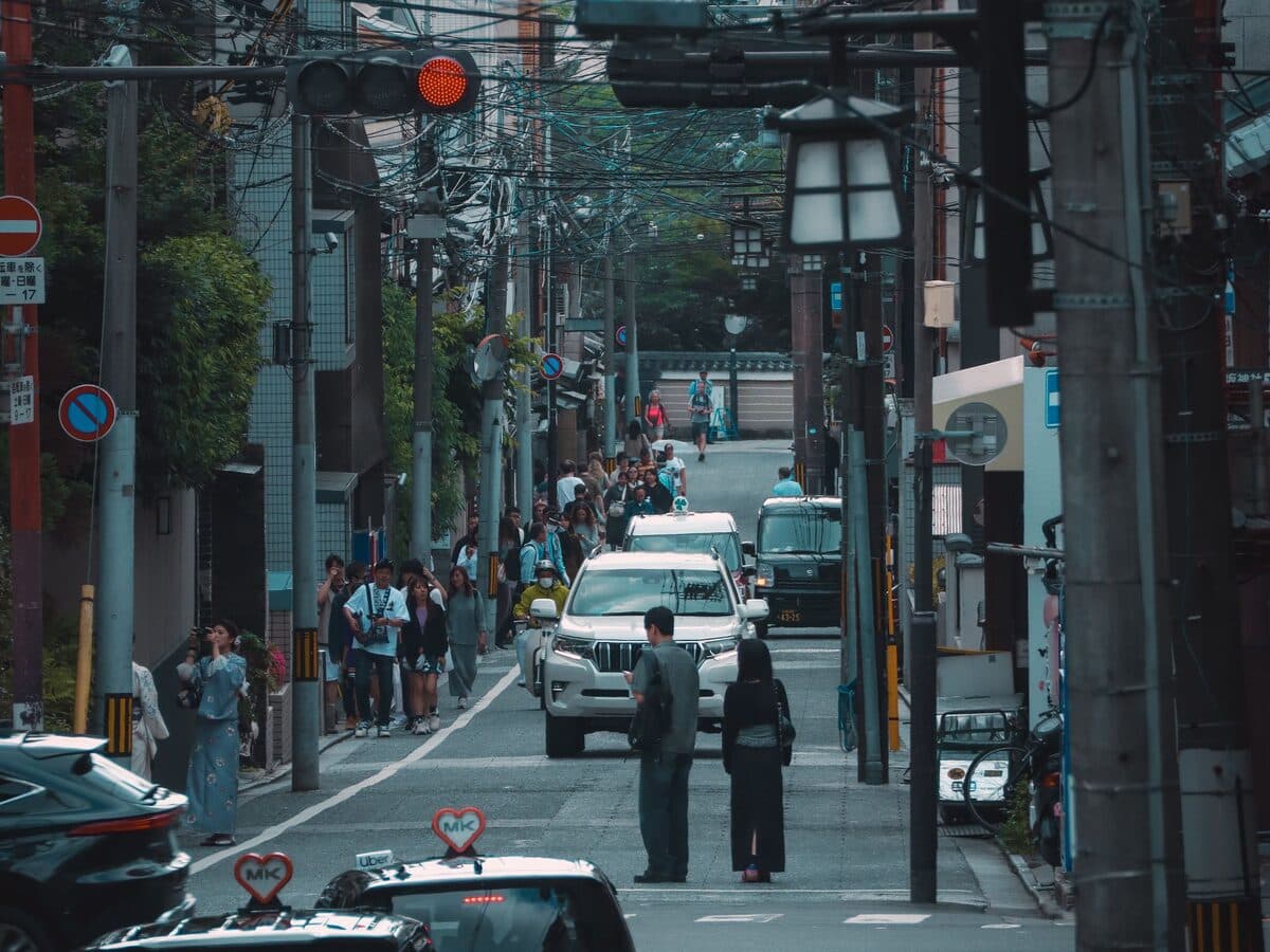 Small Japanese cars parked along a narrow Tokyo side street